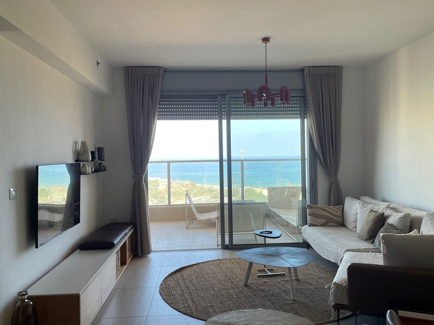 Living room with corner sofa facing the sea
