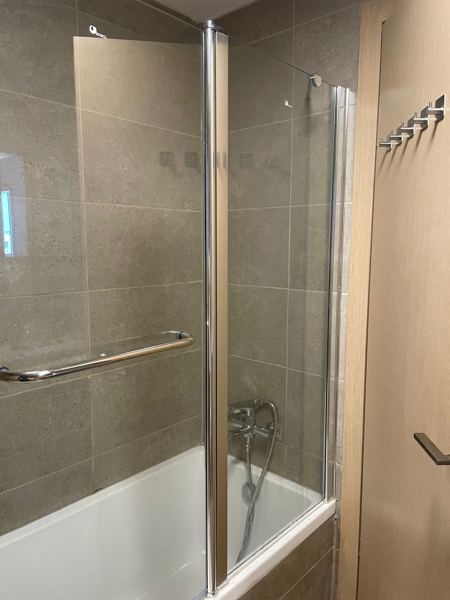 Walk-in shower with chrome fixtures